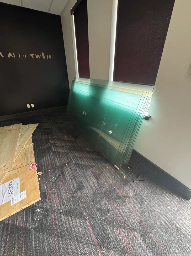 Austin commercial office interior stripped out, large glass panels leaned against the wall