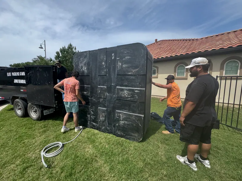 Crew moving a hot tub shell to the trailer on a San Marcos hot tub removal
